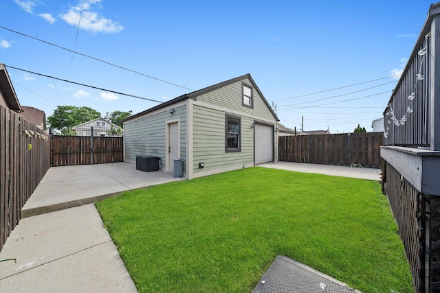 6205 W Grace St, Chicago, IL 60634 - back of property featuring a patio area, a detached garage, and an outbuilding