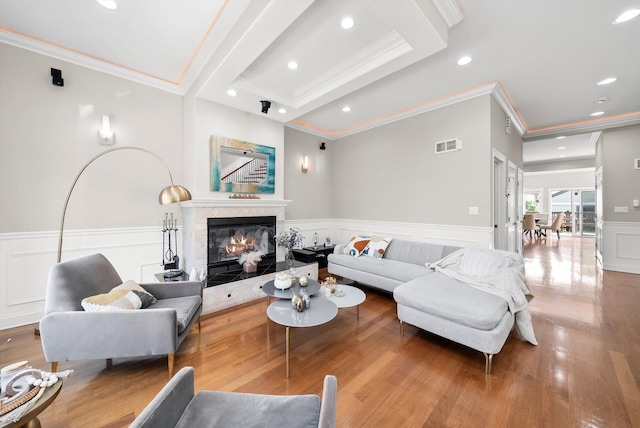 6205 W Grace St, Chicago, IL 60634 - living room featuring crown molding, wood finished floors, a decorative wall, recessed lighting, and wainscoting