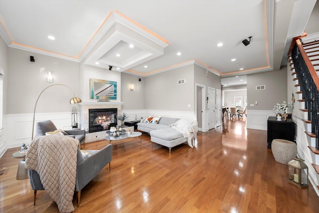6205 W Grace St, Chicago, IL 60634 - living room featuring stairway, a decorative wall, ornamental molding, a glass covered fireplace, and wainscoting