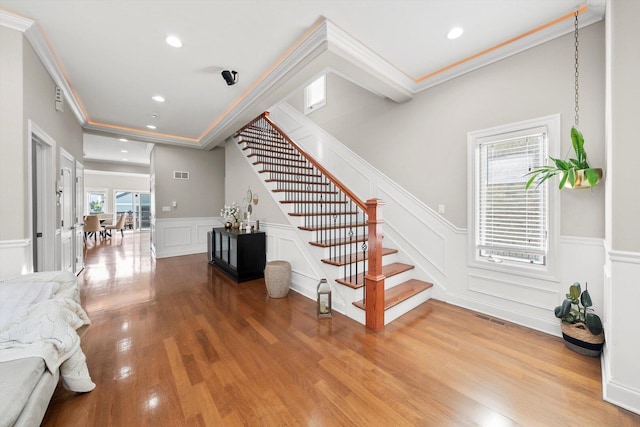 6205 W Grace St, Chicago, IL 60634 - stairs with a decorative wall, recessed lighting, crown molding, wood finished floors, and a wainscoted wall