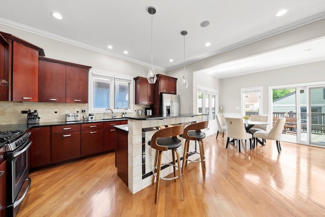 6205 W Grace St, Chicago, IL 60634 - kitchen with stainless steel appliances, light wood finished floors, healthy amount of natural light, a center island, and recessed lighting