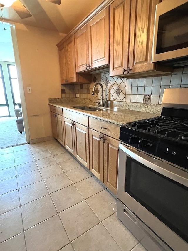 6700 S S Shore Dr Unit 17A, Chicago, IL 60649 - kitchen with stainless steel appliances, a sink, backsplash, and light tile patterned floors
