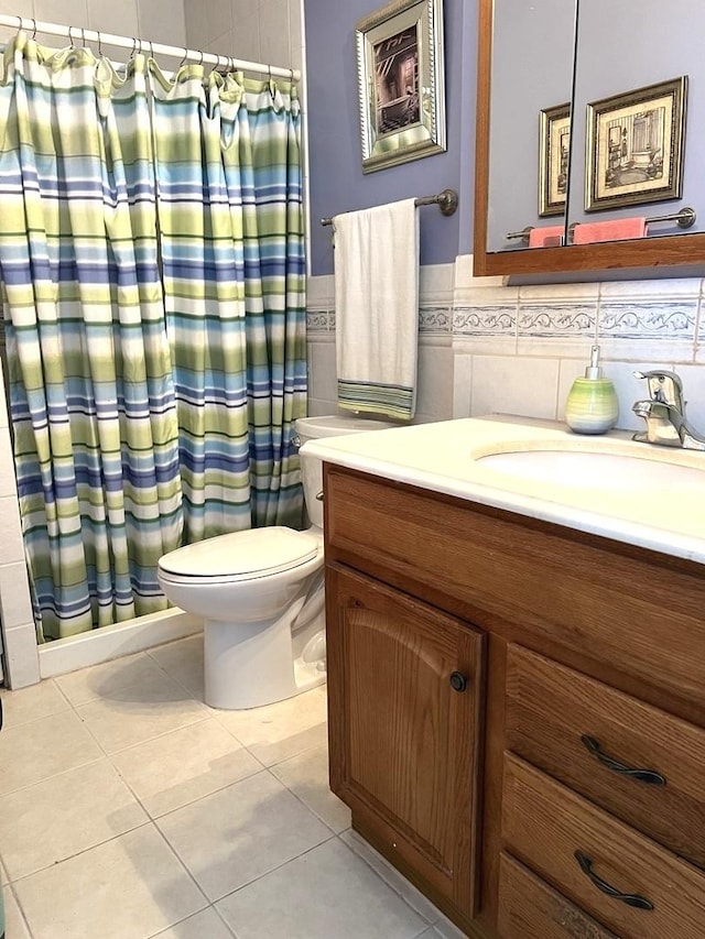6700 S S Shore Dr Unit 17A, Chicago, IL 60649 - bathroom with vanity, tile walls, toilet, tile patterned floors, and a shower with shower curtain