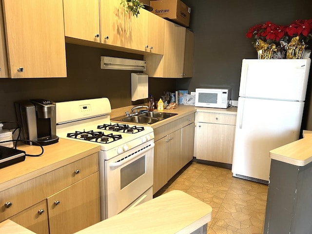 6700 S S Shore Dr Unit 17A, Chicago, IL 60649 - kitchen with white appliances, light countertops, a sink, light brown cabinets, and light floors