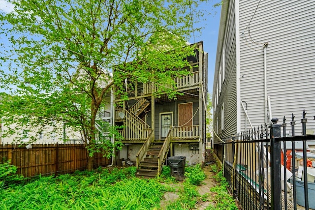 6146 S Morgan St, Chicago, IL 60621 - back of house with stairs and a fenced backyard
