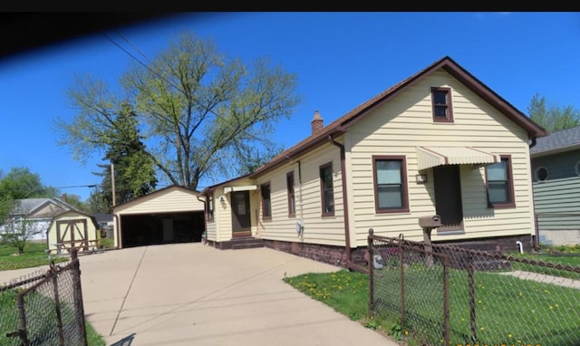 208 N Farnsworth Ave, Aurora, IL 60505 - view of front of home with an outbuilding, a chimney, a detached garage, and entry steps