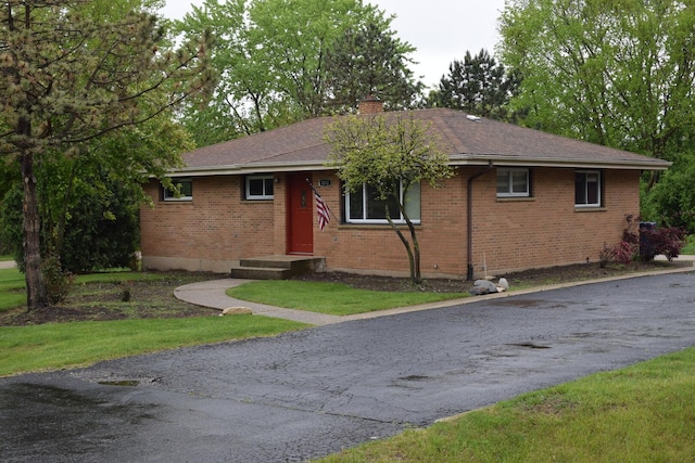 1012 Elsie Ave, Gurnee, IL 60031 - ranch-style house with a chimney, brick siding, a front lawn, and asphalt driveway