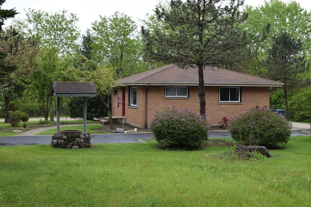 1012 Elsie Ave, Gurnee, IL 60031 - view of property exterior featuring a lawn, brick siding, a shingled roof, and asphalt driveway