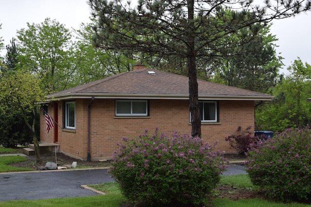 1012 Elsie Ave, Gurnee, IL 60031 - view of side of home featuring brick siding, a chimney, and a shingled roof