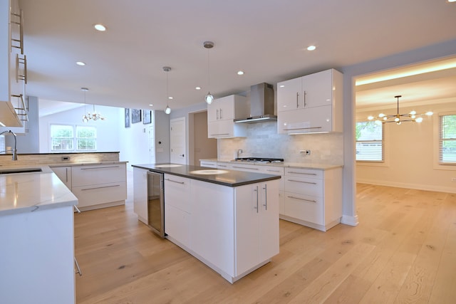 3548 Grandmore Ave, Gurnee, IL 60031 - kitchen with wall chimney exhaust hood, a chandelier, beverage cooler, decorative backsplash, and gas stovetop