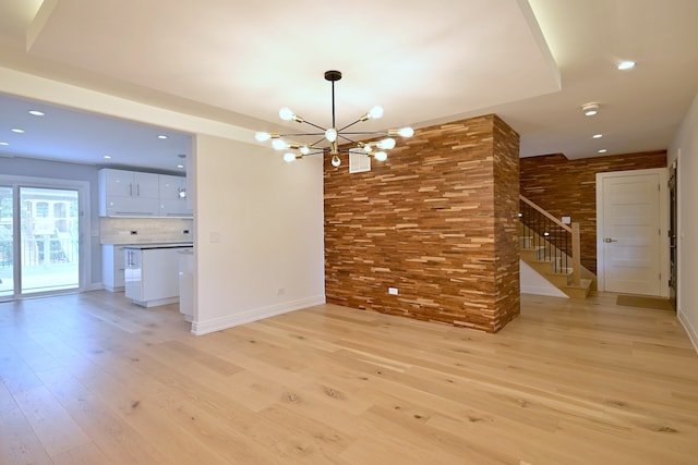 3548 Grandmore Ave, Gurnee, IL 60031 - unfurnished living room with a chandelier, light wood-style flooring, recessed lighting, stairs, and baseboards