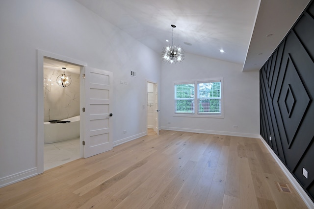 3548 Grandmore Ave, Gurnee, IL 60031 - unfurnished living room featuring a chandelier, light wood-type flooring, high vaulted ceiling, and baseboards