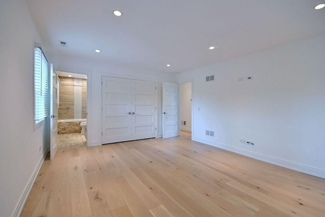 3548 Grandmore Ave, Gurnee, IL 60031 - unfurnished bedroom with light wood finished floors, recessed lighting, baseboards, and connected bathroom