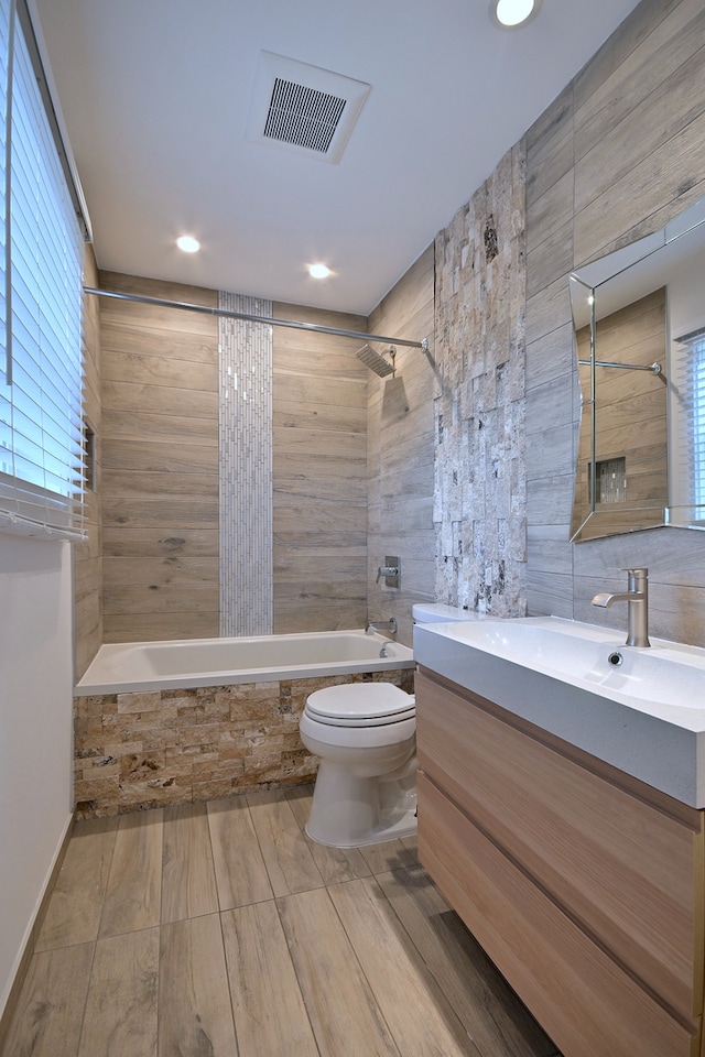 3548 Grandmore Ave, Gurnee, IL 60031 - bathroom featuring tiled shower / bath, toilet, vanity, plenty of natural light, and recessed lighting