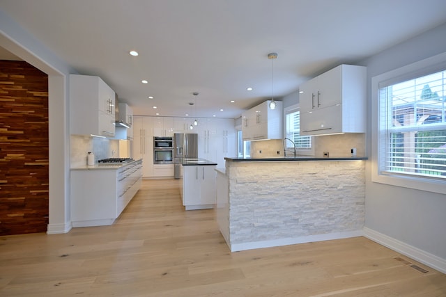 3548 Grandmore Ave, Gurnee, IL 60031 - kitchen with stainless steel appliances, tasteful backsplash, white cabinets, a peninsula, and recessed lighting