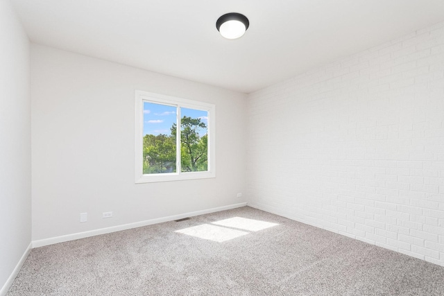 334 Ashland Ave, Highwood, IL 60040 - carpeted spare room with baseboards and brick wall