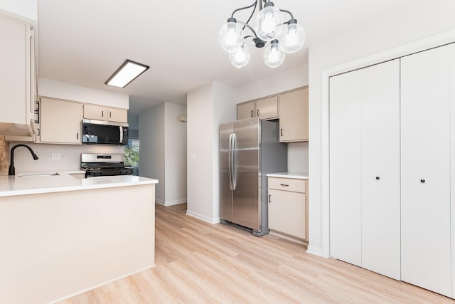 334 Ashland Ave, Highwood, IL 60040 - kitchen with stainless steel appliances, a sink, light wood-style floors, and light countertops