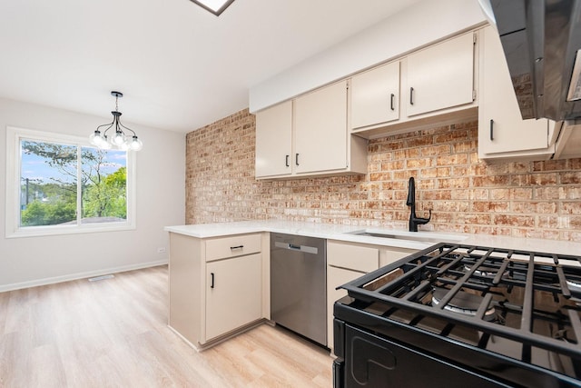 334 Ashland Ave, Highwood, IL 60040 - kitchen featuring stainless steel dishwasher, a sink, black range with gas cooktop, light countertops, and backsplash
