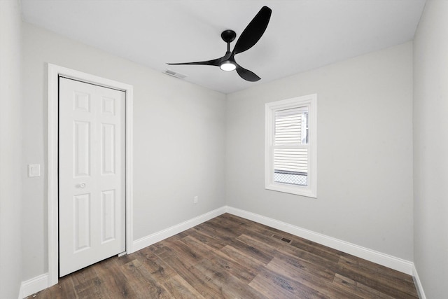 1326 N Poplar Ave, Round Lake Beach, IL 60073 - unfurnished bedroom featuring dark wood-style flooring, ceiling fan, and a closet