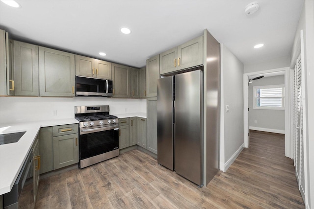 1326 N Poplar Ave, Round Lake Beach, IL 60073 - kitchen featuring stainless steel appliances, light wood-style floors, light countertops, recessed lighting, and gray cabinets