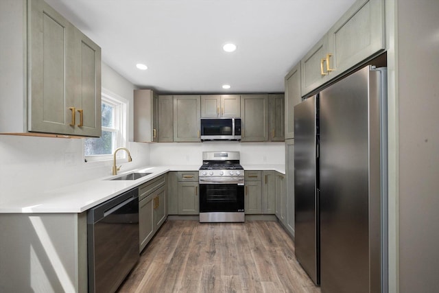1326 N Poplar Ave, Round Lake Beach, IL 60073 - kitchen with stainless steel appliances, wood finished floors, gray cabinetry, light countertops, and recessed lighting