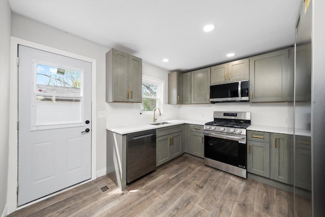 1326 N Poplar Ave, Round Lake Beach, IL 60073 - kitchen with stainless steel appliances, gray cabinetry, wood finished floors, light countertops, and recessed lighting
