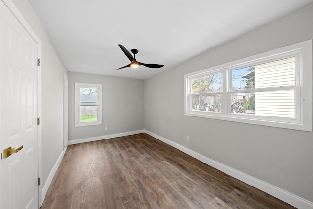 1326 N Poplar Ave, Round Lake Beach, IL 60073 - unfurnished bedroom featuring multiple windows, wood finished floors, and a ceiling fan