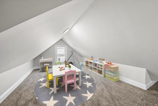 1326 N Poplar Ave, Round Lake Beach, IL 60073 - rec room featuring carpet floors and vaulted ceiling