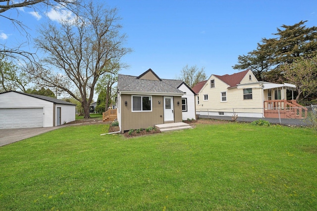 1326 N Poplar Ave, Round Lake Beach, IL 60073 - view of front of home featuring a detached garage, an outbuilding, a front lawn, and roof with shingles
