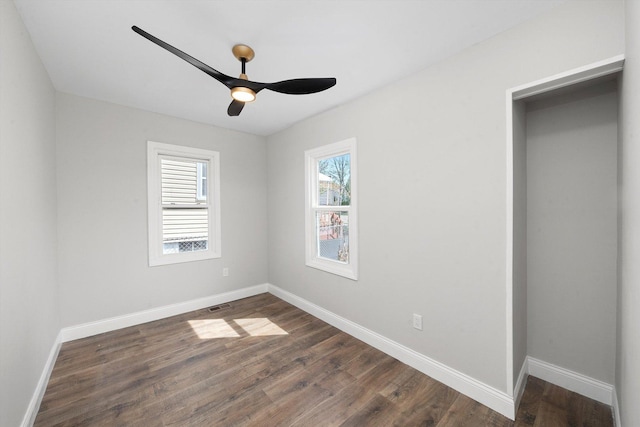 1326 N Poplar Ave, Round Lake Beach, IL 60073 - unfurnished bedroom with dark wood-style flooring and ceiling fan