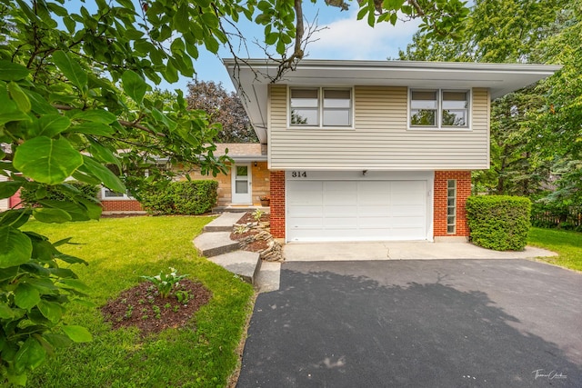 314 Oak Ave, Westmont, IL 60559 - split level home with asphalt driveway, brick siding, an attached garage, and a front lawn