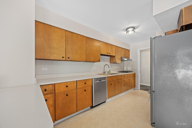 314 Oak Ave, Westmont, IL 60559 - kitchen with stainless steel appliances, light countertops, under cabinet range hood, and brown cabinets