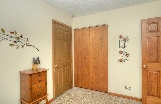 4585 Zeppelin Dr, Hanover Park, IL 60133 - bedroom featuring a closet, light colored carpet, a textured ceiling, and baseboards