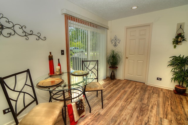4585 Zeppelin Dr, Hanover Park, IL 60133 - dining space with a textured ceiling, wood finished floors, and baseboards