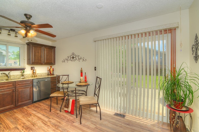4585 Zeppelin Dr, Hanover Park, IL 60133 - kitchen with stainless steel dishwasher, light wood-type flooring, a textured ceiling, a sink, and a ceiling fan