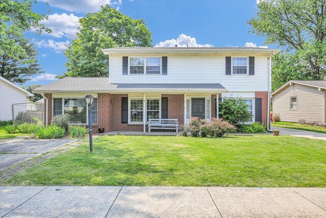 2107 Barberry Dr, Champaign, IL 61821 - traditional-style home with covered porch, brick siding, and a front yard