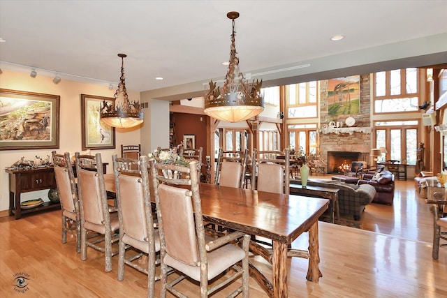 4776A W State Route 102, Bourbonnais, IL 60914 - dining space featuring light wood-type flooring, a fireplace, recessed lighting, and rail lighting