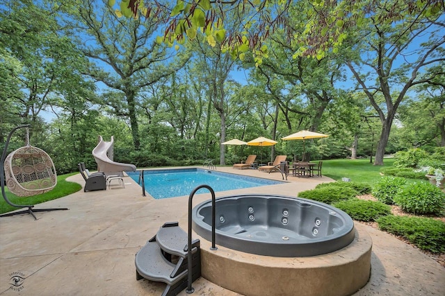 4776A W State Route 102, Bourbonnais, IL 60914 - swimming pool featuring a water slide, a jacuzzi, a patio area, and view of wooded area