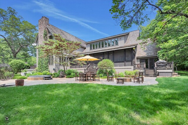 4776A W State Route 102, Bourbonnais, IL 60914 - rear view of property with a patio, a sunroom, a deck, a lawn, and an outdoor fire pit