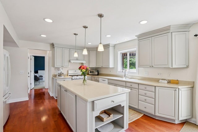 63 E Cambridge Ct, Grayslake, IL 60030 - kitchen with white appliances, under cabinet range hood, light countertops, a center island, and wood finished floors