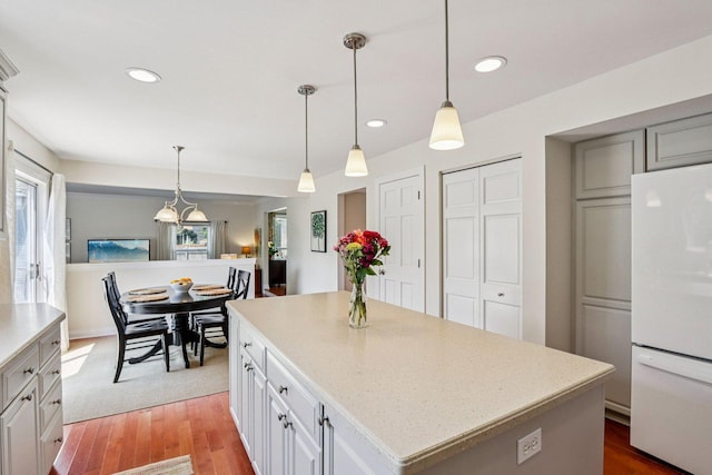 63 E Cambridge Ct, Grayslake, IL 60030 - kitchen with freestanding refrigerator, a kitchen island, recessed lighting, light wood finished floors, and decorative light fixtures