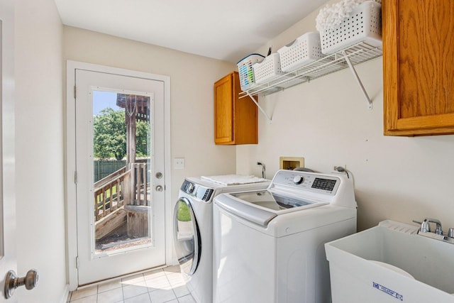 63 E Cambridge Ct, Grayslake, IL 60030 - laundry area featuring washing machine and clothes dryer, cabinet space, and light tile patterned floors