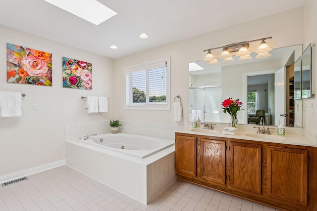 63 E Cambridge Ct, Grayslake, IL 60030 - full bathroom featuring a skylight, double vanity, tile patterned flooring, a tub with jets, and plenty of natural light