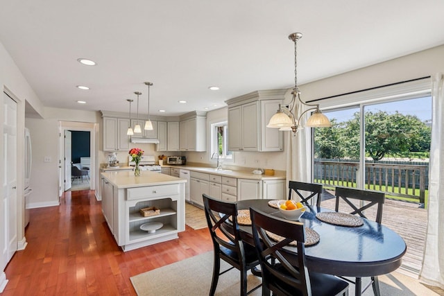 63 E Cambridge Ct, Grayslake, IL 60030 - kitchen with light countertops, open shelves, white appliances, a kitchen island, and wood finished floors