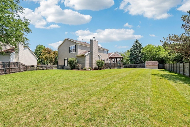 63 E Cambridge Ct, Grayslake, IL 60030 - fenced backyard featuring a gazebo and a storage unit