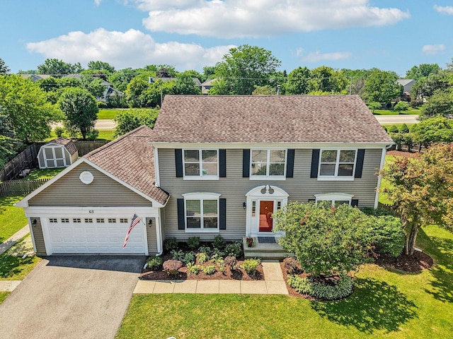 63 E Cambridge Ct, Grayslake, IL 60030 - colonial inspired home with driveway, a garage, a shed, and roof with shingles