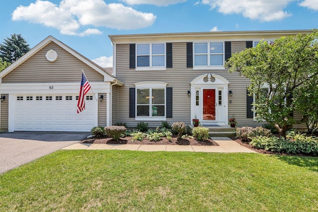 63 E Cambridge Ct, Grayslake, IL 60030 - colonial house featuring asphalt driveway, a garage, and a front lawn