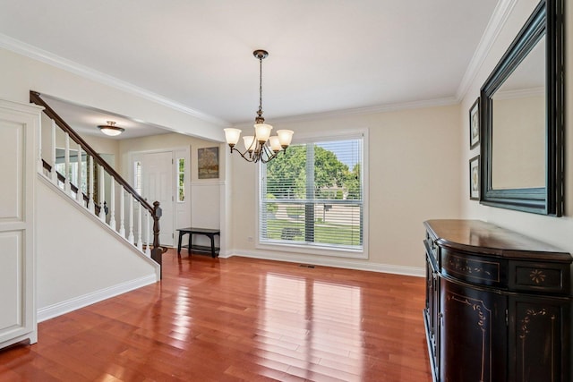 63 E Cambridge Ct, Grayslake, IL 60030 - unfurnished dining area with wood finished floors, stairs, a chandelier, and crown molding
