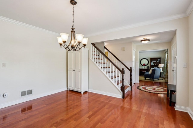 63 E Cambridge Ct, Grayslake, IL 60030 - entrance foyer featuring wood finished floors, stairs, a chandelier, and ornamental molding
