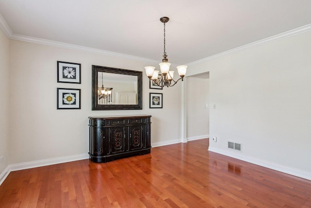 63 E Cambridge Ct, Grayslake, IL 60030 - spare room with a chandelier, wood finished floors, and ornamental molding